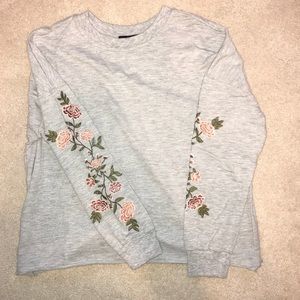 Grey crew neck with floral detailing on sleeves